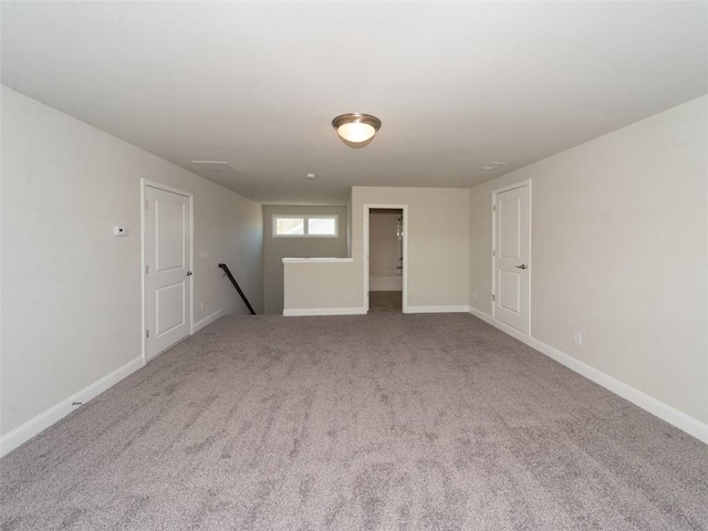 empty room with light carpet and baseboards