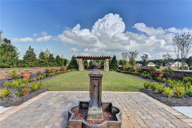 view of property's community featuring a patio area, a yard, fence, and a pergola