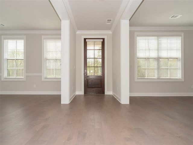 foyer with ornamental molding, dark wood finished floors, and visible vents