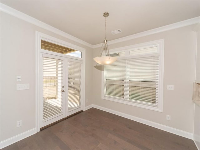 unfurnished dining area featuring dark wood-style floors, french doors, visible vents, ornamental molding, and baseboards