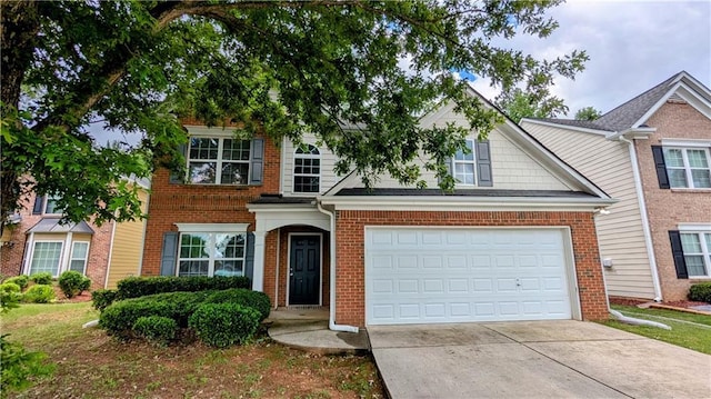 view of front of house with driveway, brick siding, and a garage