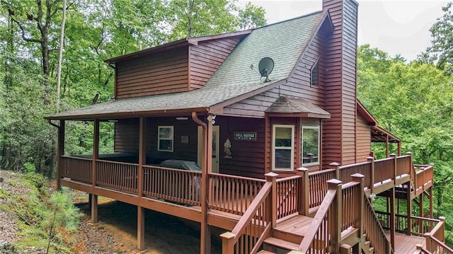 rear view of house with a wooden deck