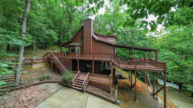 back of house with a patio area and a wooden deck