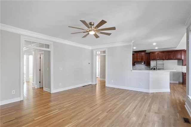 unfurnished living room featuring light hardwood / wood-style flooring, ornamental molding, and ceiling fan