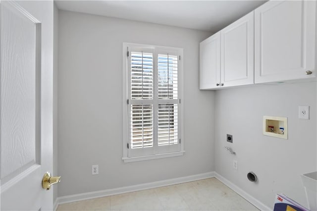 clothes washing area with electric dryer hookup, washer hookup, and cabinets