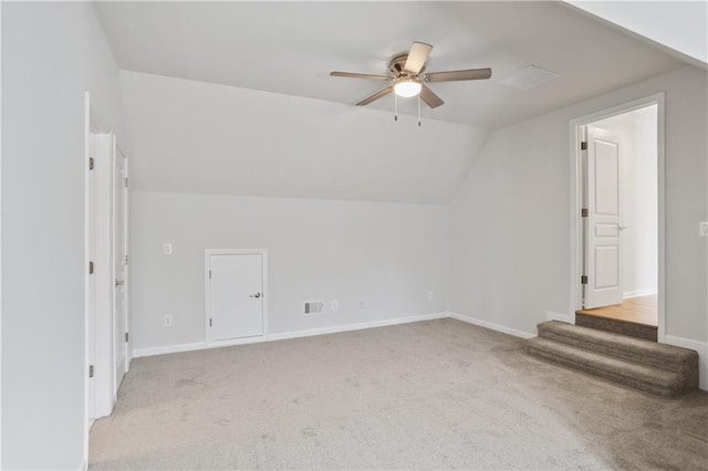 additional living space featuring lofted ceiling, light colored carpet, and ceiling fan