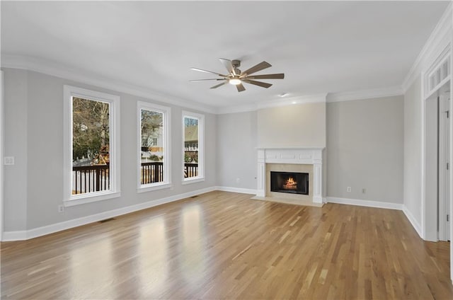 unfurnished living room with ornamental molding, ceiling fan, and light hardwood / wood-style floors