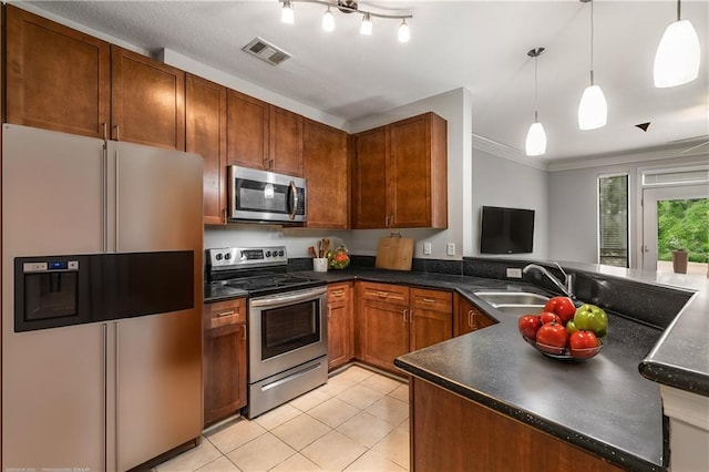 kitchen featuring appliances with stainless steel finishes, decorative light fixtures, sink, ornamental molding, and light tile patterned floors