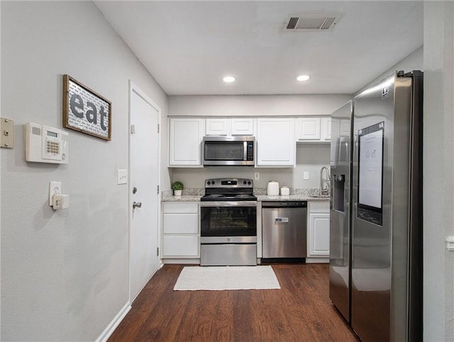 3149 Buford Hwy Unit 3, Brookhaven, GA 30329 - kitchen featuring appliances with stainless steel finishes, dark wood-style flooring, white cabinetry, a sink, and recessed lighting