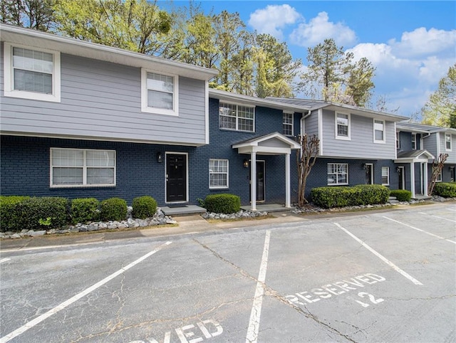 3149 Buford Hwy Unit 3, Brookhaven, GA 30329 - view of property with uncovered parking and brick siding