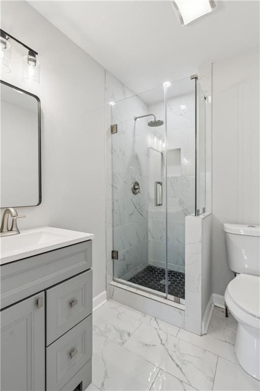 full bath featuring baseboards, marble finish floor, a marble finish shower, and toilet