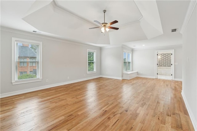 spare room with crown molding, visible vents, and a raised ceiling