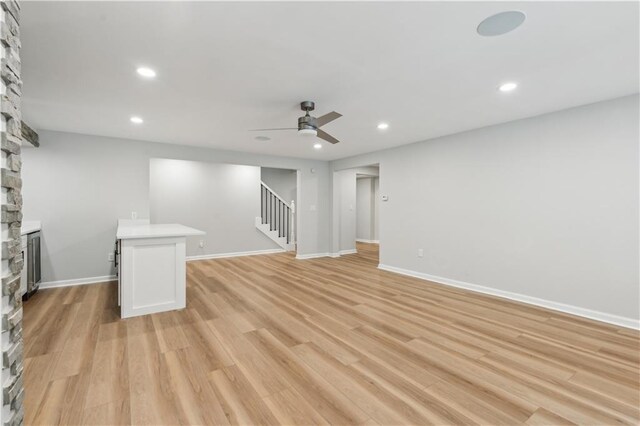 interior space with stairs, recessed lighting, ceiling fan, and a fireplace