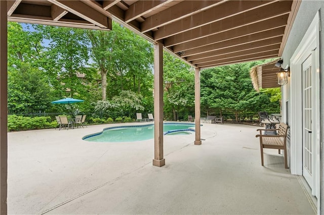 outdoor pool with a patio area and fence