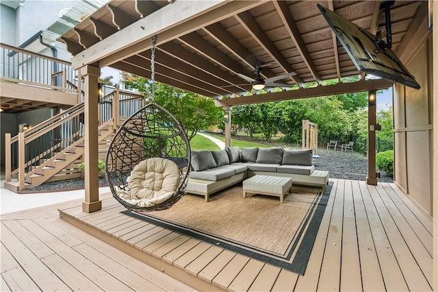 deck featuring ceiling fan, outdoor lounge area, and stairway
