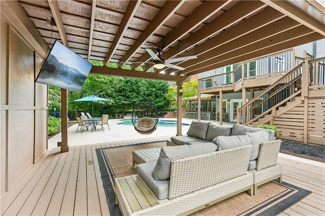 deck with an outdoor pool, an outdoor hangout area, a ceiling fan, stairway, and outdoor dining space
