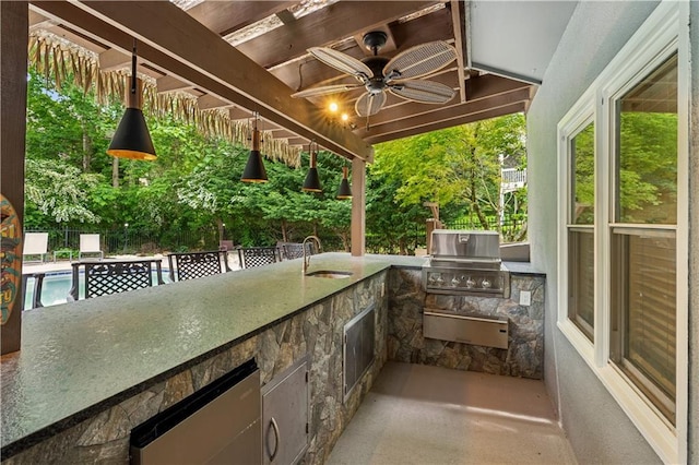 view of patio / terrace featuring area for grilling, fence, a ceiling fan, and a sink