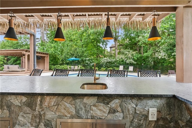 exterior space featuring a sink and stone siding