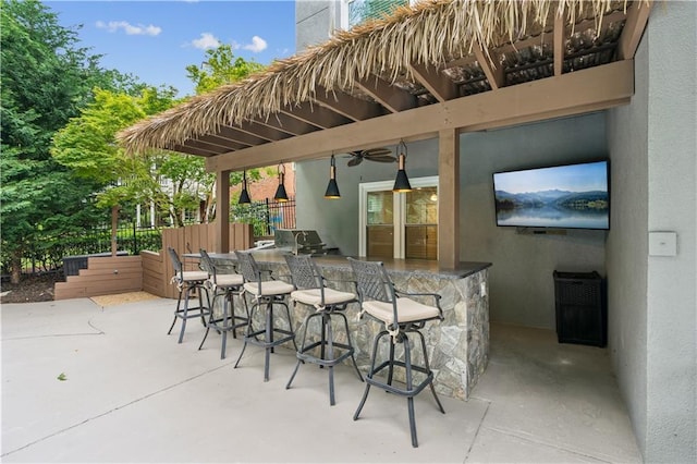 view of patio featuring fence, a ceiling fan, and outdoor wet bar