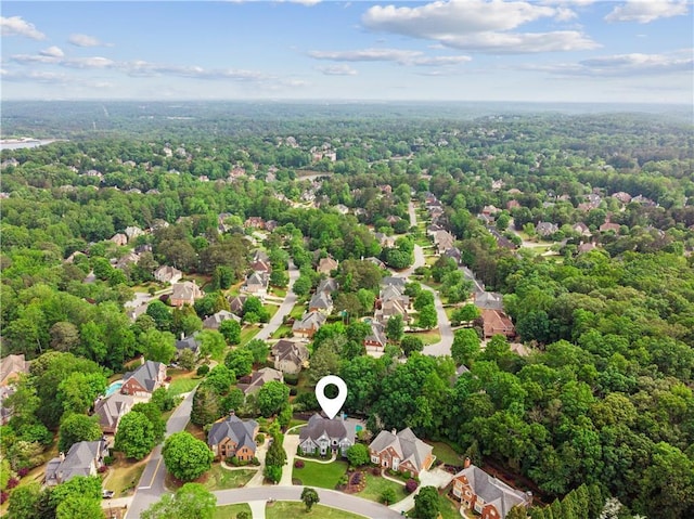 birds eye view of property featuring a residential view and a view of trees