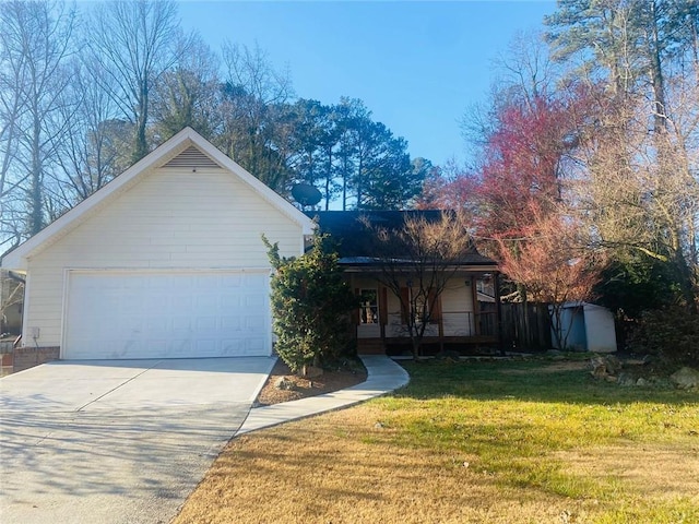 ranch-style house featuring a front lawn, a garage, and covered porch