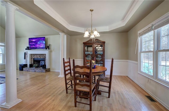108 Arbor Hills Trl, Talking Rock, GA 30175 - dining room with light wood-style flooring, visible vents, a healthy amount of sunlight, a tray ceiling, and decorative columns