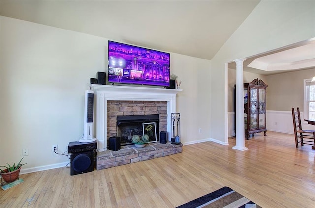 108 Arbor Hills Trl, Talking Rock, GA 30175 - living room with baseboards, wood finished floors, vaulted ceiling, a stone fireplace, and ornate columns