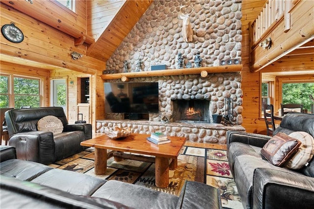 living room with a fireplace, high vaulted ceiling, wooden walls, and wood ceiling