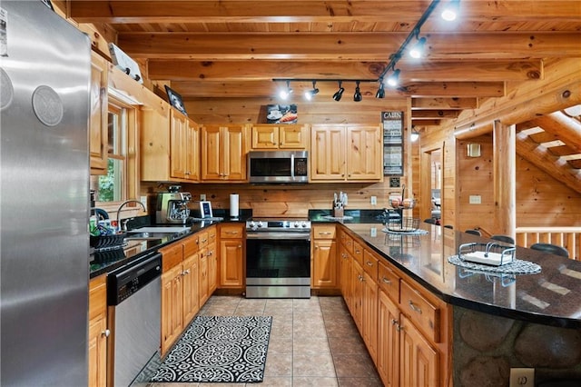 kitchen with sink, light tile patterned floors, beamed ceiling, wood ceiling, and stainless steel appliances