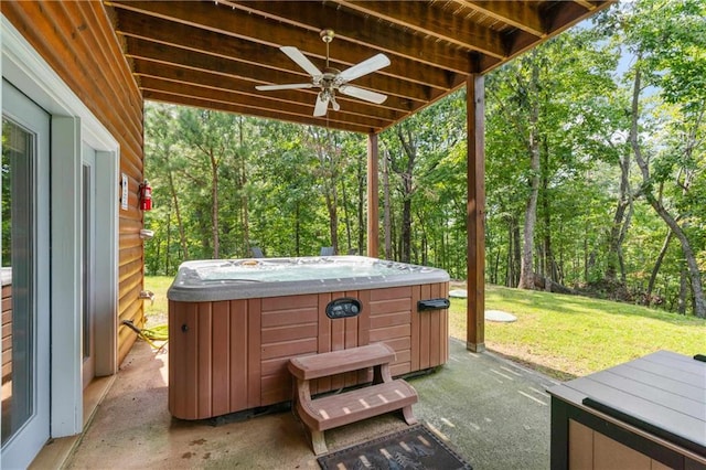 view of patio with ceiling fan and a hot tub