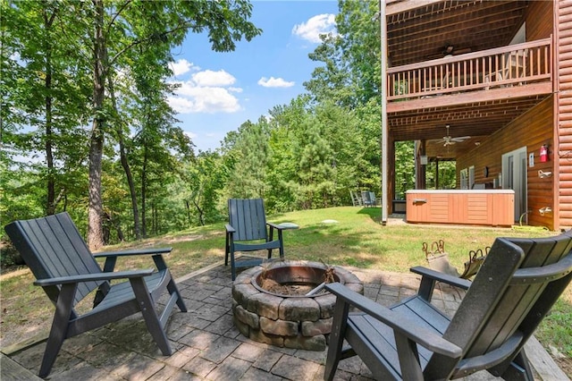 view of patio / terrace featuring ceiling fan, a deck, and an outdoor fire pit