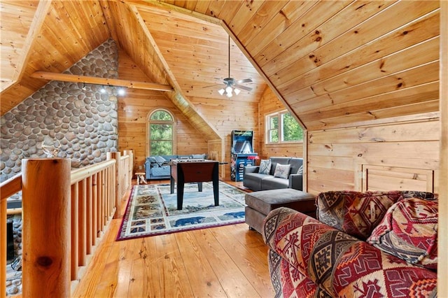 game room featuring ceiling fan, wood walls, vaulted ceiling, wood ceiling, and hardwood / wood-style flooring