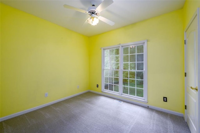 carpeted spare room with baseboards and ceiling fan