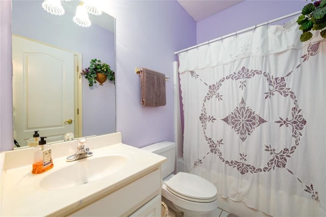 bathroom with toilet, vanity, and shower / bathtub combination with curtain