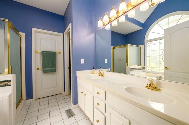 full bathroom with a stall shower, tile patterned flooring, a garden tub, double vanity, and baseboards