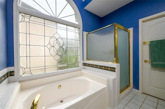 bathroom featuring a shower stall, healthy amount of natural light, a bath, and tile patterned floors