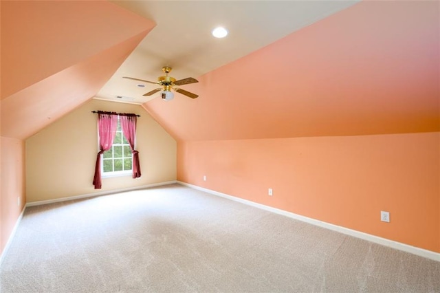 bonus room featuring carpet floors, lofted ceiling, baseboards, and a ceiling fan