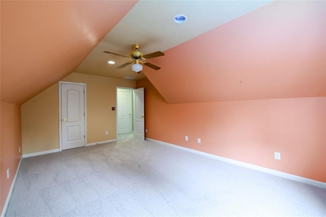 additional living space featuring light carpet, lofted ceiling, baseboards, ceiling fan, and recessed lighting
