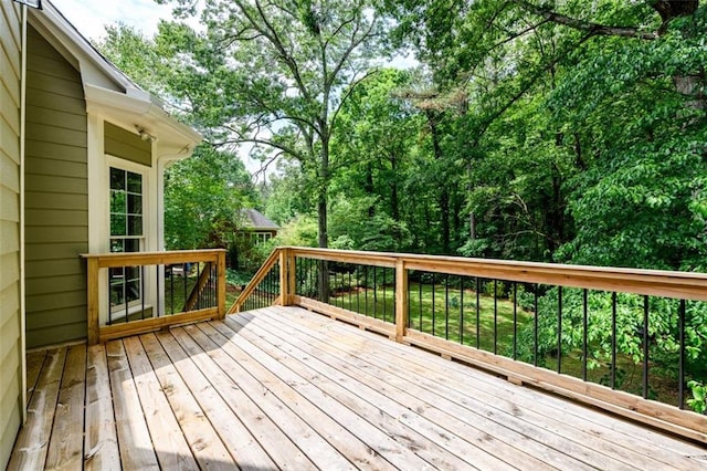 deck featuring view of scattered trees