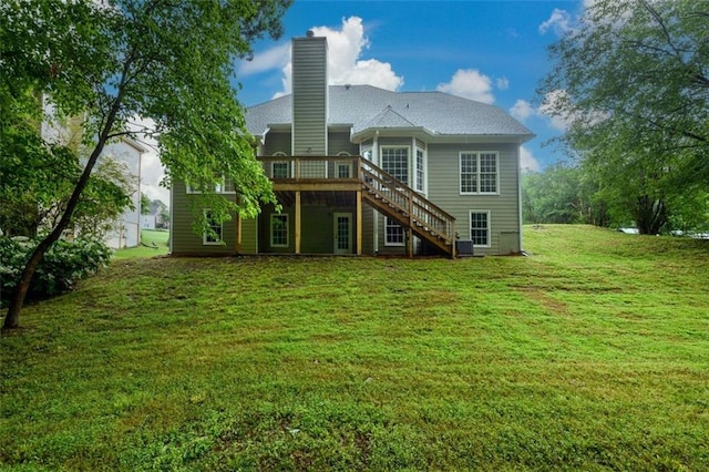 rear view of property featuring stairway, a deck, a chimney, a yard, and central air condition unit