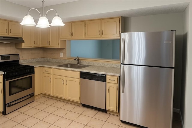 5581 Marbut Rd, Lithonia, GA 30058 - kitchen with stainless steel appliances, under cabinet range hood, light countertops, light tile patterned flooring, and decorative backsplash