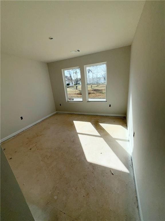 spare room featuring visible vents and baseboards