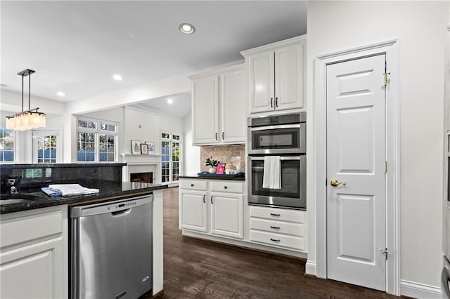 kitchen featuring decorative backsplash, recessed lighting, dark wood-style floors, white cabinets, and stainless steel appliances