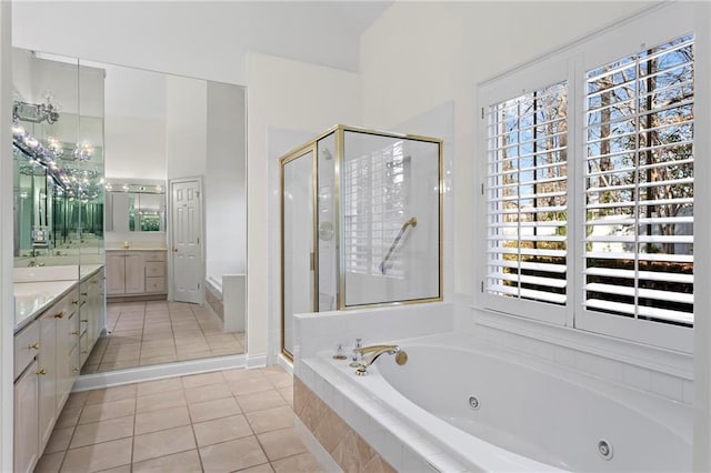 bathroom with vanity, a tub with jets, a stall shower, and tile patterned flooring