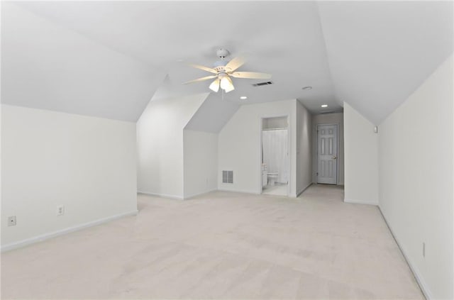 additional living space with lofted ceiling, baseboards, and visible vents