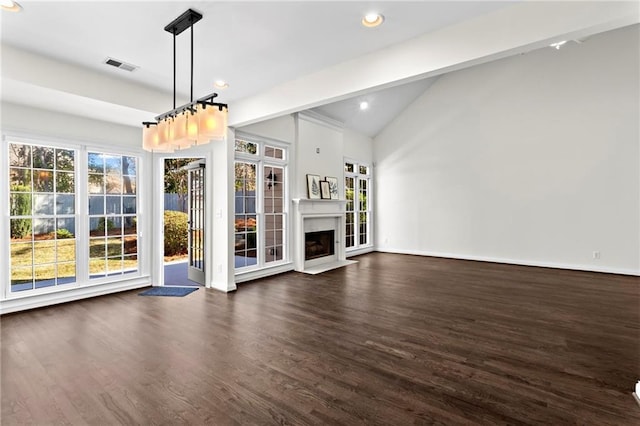 unfurnished living room featuring dark wood-style floors, visible vents, plenty of natural light, and a fireplace