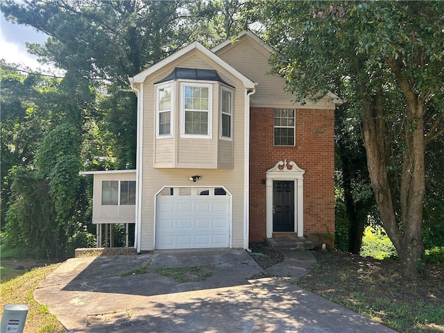 5000 Saxony Ct, Stone Mountain, GA 30083 - view of front facade featuring driveway, a garage, and brick siding