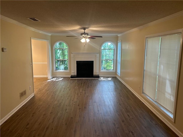 5000 Saxony Ct, Stone Mountain, GA 30083 - unfurnished living room with dark wood finished floors, plenty of natural light, ceiling fan, ornamental molding, and a fireplace with raised hearth