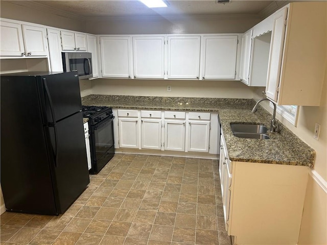 5000 Saxony Ct, Stone Mountain, GA 30083 - kitchen featuring black appliances, white cabinets, dark stone counters, stone finish floors, and ornamental molding