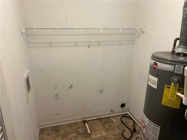 5000 Saxony Ct, Stone Mountain, GA 30083 - washroom with water heater, electric dryer hookup, and stone finish floors